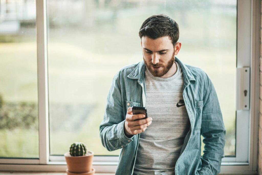 gentleman using mobile marketing on his phone